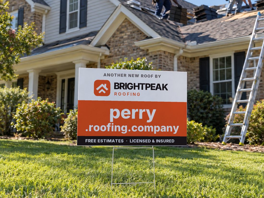 perry.roofing.company on a yard sign in front of a house getting a new roof